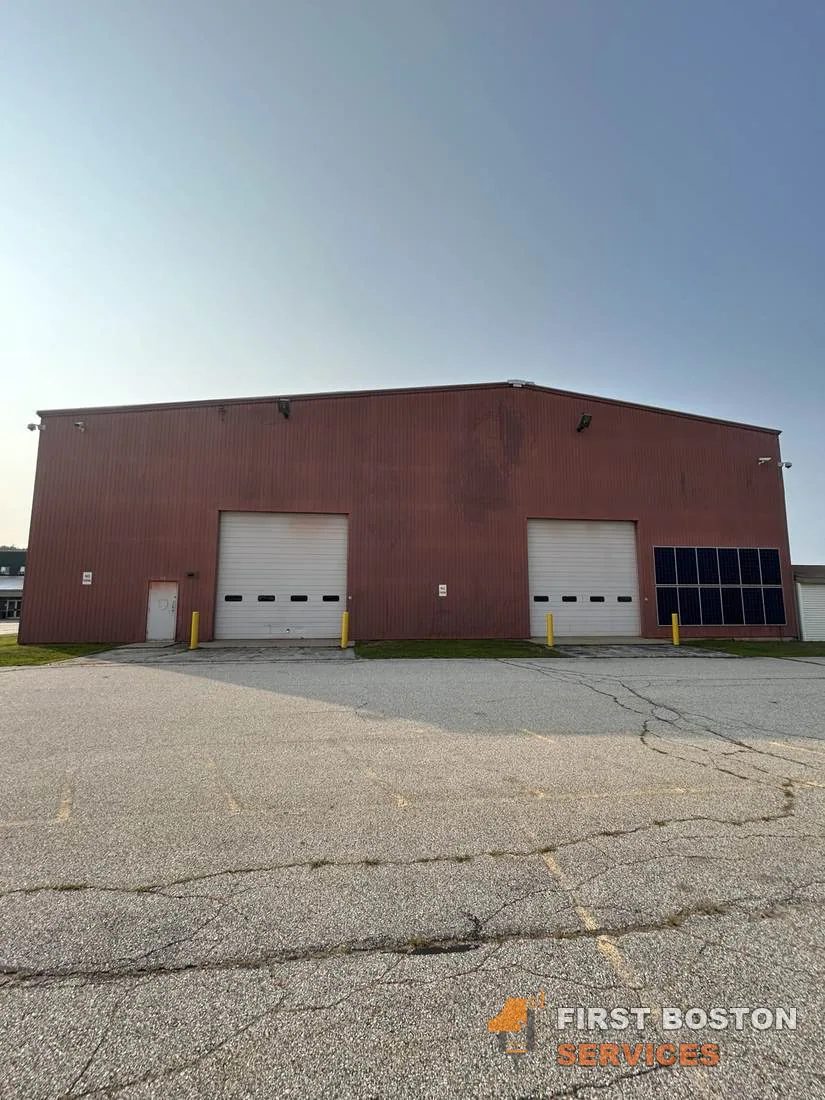 First Boston Services: Front elevation before: faded red metal siding