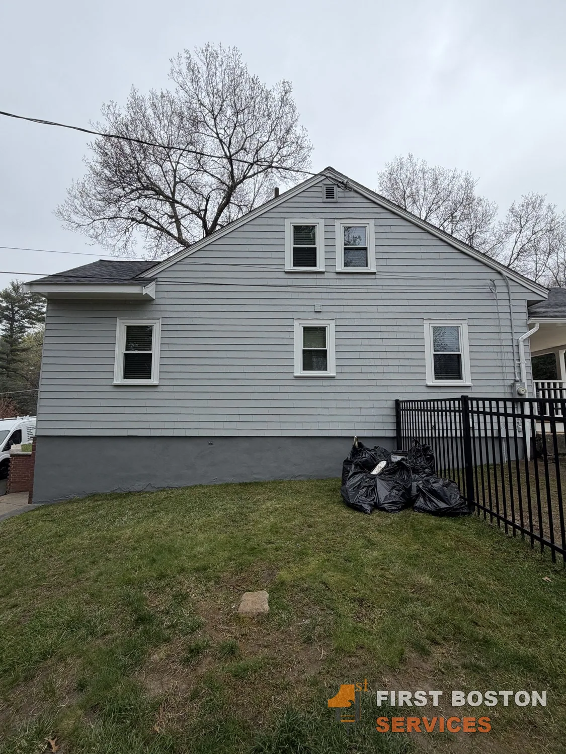 First Boston Services: Rear wall after: light gray siding, white trim