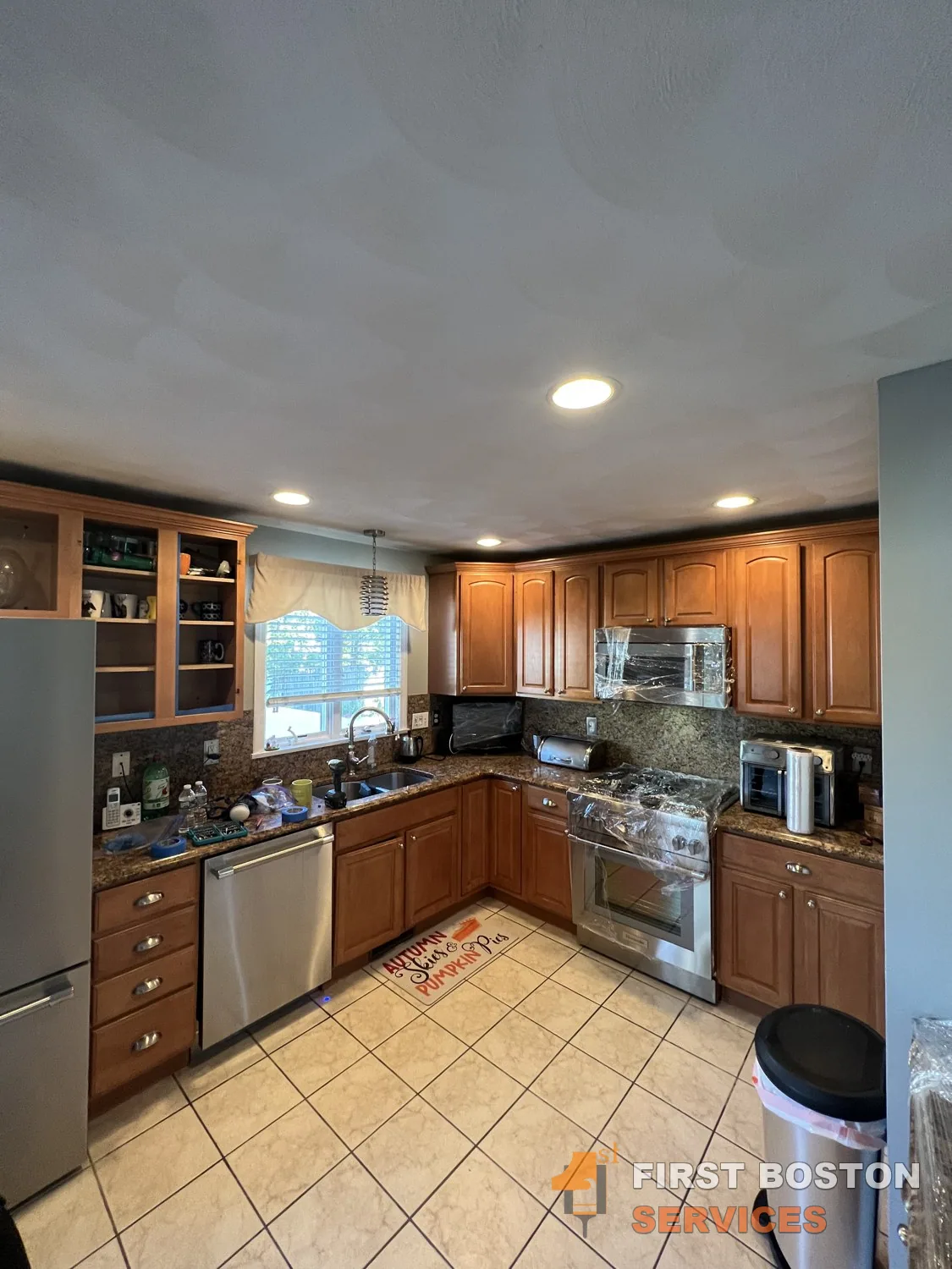 First Boston Services: Kitchen before: stained wood cabinets
